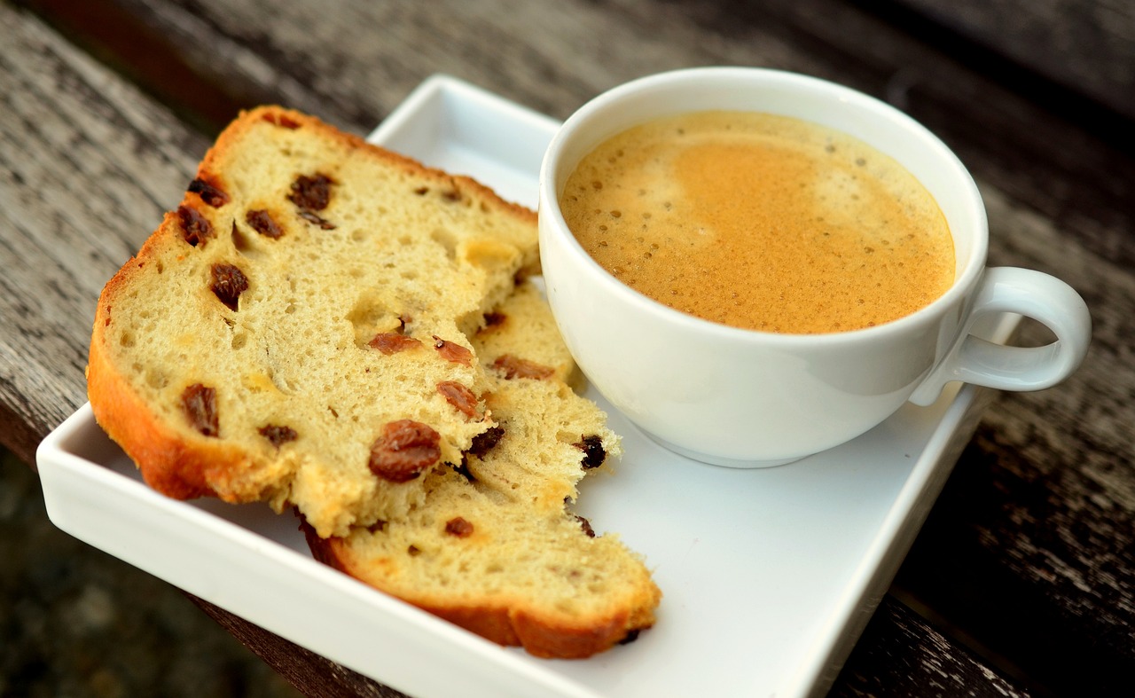 Coffee and raisin bread on a white tray
